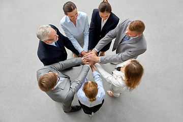 Image showing happy business people stacking hands