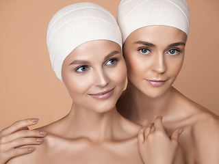 Image showing Portrait of beautiful young women isolated on brown studio background