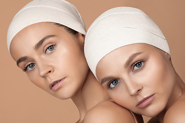 Image showing Portrait of beautiful young women isolated on brown studio background