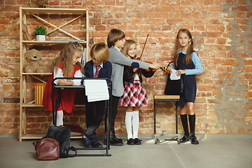 Image showing Group of kids spending time after school together. Handsome frie