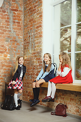 Image showing Group of kids spending time after school together. Handsome friends resting after classes.