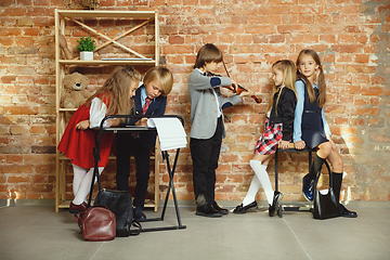 Image showing Group of kids spending time after school together. Handsome friends resting after classes.