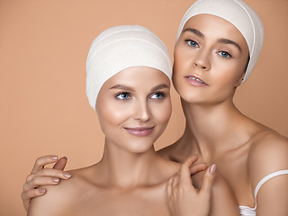 Image showing Portrait of beautiful young women isolated on brown studio background