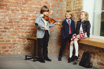 Image showing Group of kids spending time after school together. Handsome frie