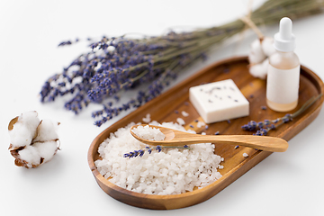 Image showing sea salt, lavender soap and serum on wooden tray