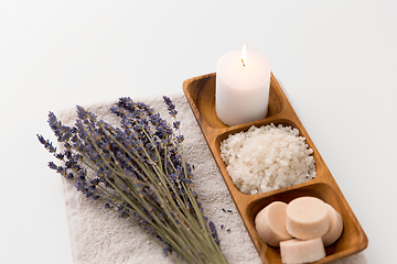 Image showing sea salt, soap, candle and lavender on bath towel