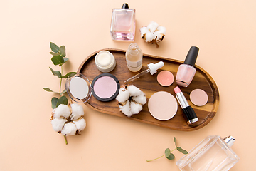 Image showing makeup, perfume and cosmetics on wooden tray