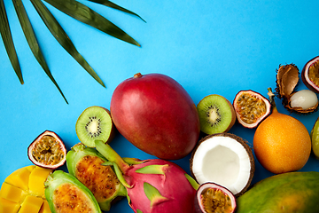 Image showing different exotic fruits on blue background