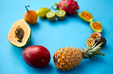 Image showing different exotic fruits on blue background