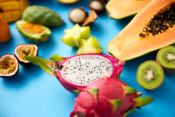 Image showing different exotic fruits on blue background