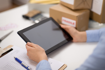 Image showing hands with tablet pc and clipboard at post office