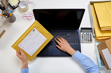 Image showing hands with laptop and envelope at post office