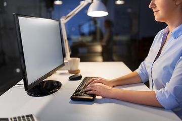 Image showing businesswoman working on computer at night office