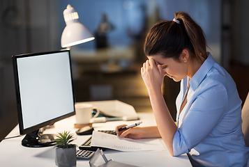 Image showing businesswoman with papers working at night office