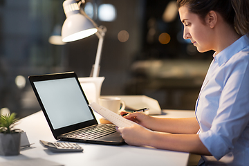 Image showing businesswoman with papers working at night office