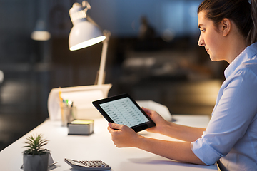 Image showing businesswoman with tablet computer at night office