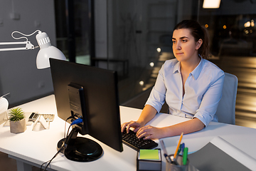Image showing businesswoman working on computer at night office