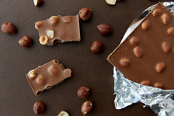 Image showing milk chocolate bar with hazelnuts in foil wrapper