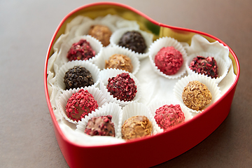 Image showing candies in red heart shaped chocolate box