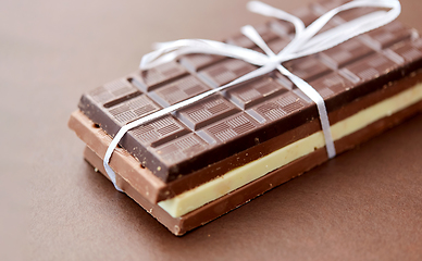 Image showing different kinds of chocolate on brown background