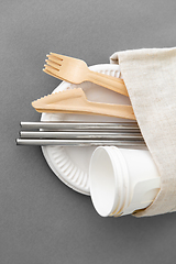 Image showing wooden forks, knives and paper cups on plate