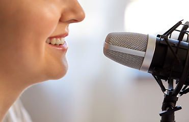 Image showing close up of woman talking to microphone