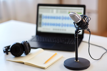 Image showing microphone, laptop, headphones, notebook on table