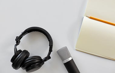 Image showing headphones, microphone and notebook with pencil