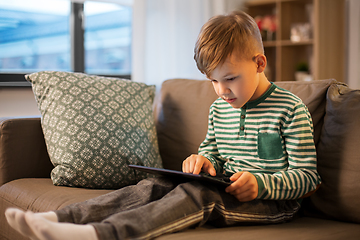 Image showing happy little boy with tablet computer at home