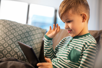 Image showing happy little boy with tablet computer at home