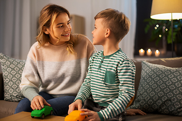 Image showing mother and son playing with toy cars at home