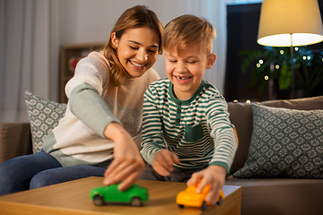 Image showing mother and son playing with toy cars at home