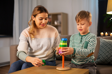 Image showing mother and son playing with toy pyramid at home