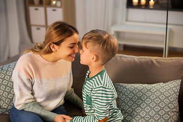 Image showing happy mother and son touching noses at home