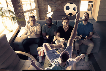 Image showing Group of excited friends playing video games at home