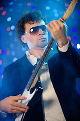 Image showing Male with guitar on stage