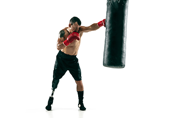 Image showing Full length portrait of muscular sportsman with prosthetic leg, copy space. Male boxer in red gloves.