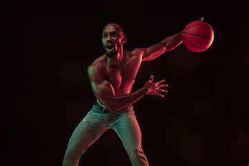 Image showing Young african-american basketball player against dark background