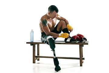 Image showing Full length portrait of muscular sportsman with prosthetic leg, copy space. Male boxer in red gloves.