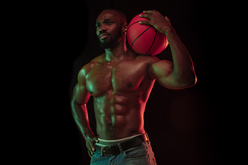 Image showing Young african-american basketball player against dark background