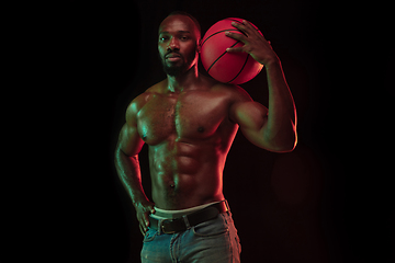 Image showing Young african-american basketball player against dark background