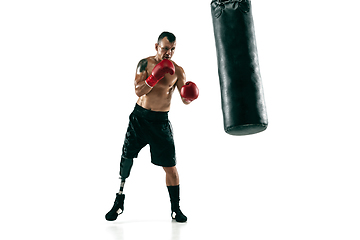 Image showing Full length portrait of muscular sportsman with prosthetic leg, copy space. Male boxer in red gloves.