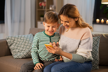 Image showing mother and son using smartphone at home
