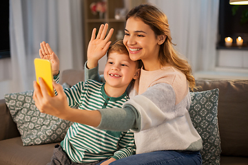 Image showing mother and son with smartphone having video call