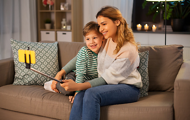 Image showing mother and son taking selfie by smartphone at home