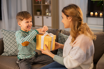 Image showing mother giving present to her little son at home