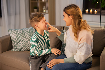 Image showing happy mother touching little son's nose at home