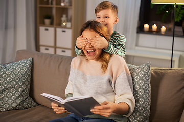 Image showing happy smiling mother playing with her son at home