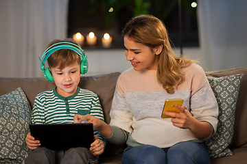 Image showing mother and son using gadgets at home