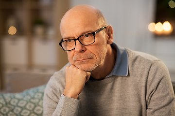 Image showing sad senior man in glasses thinking at home